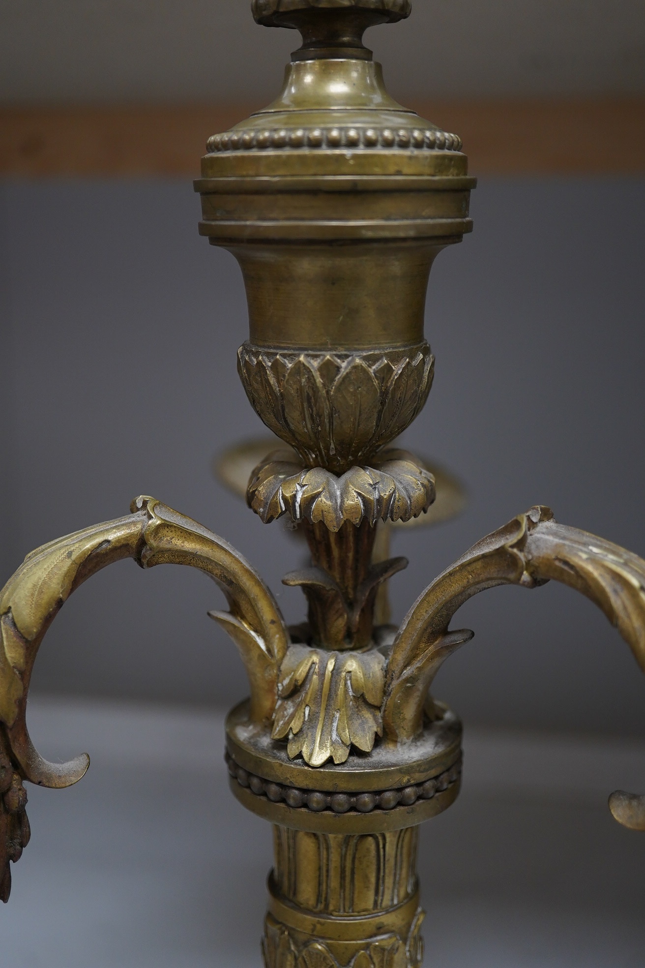 Two pairs of cut glass candlesticks and a gilt metal three branch candelabra, largest 44cm high. Condition - fair, some minor chipping